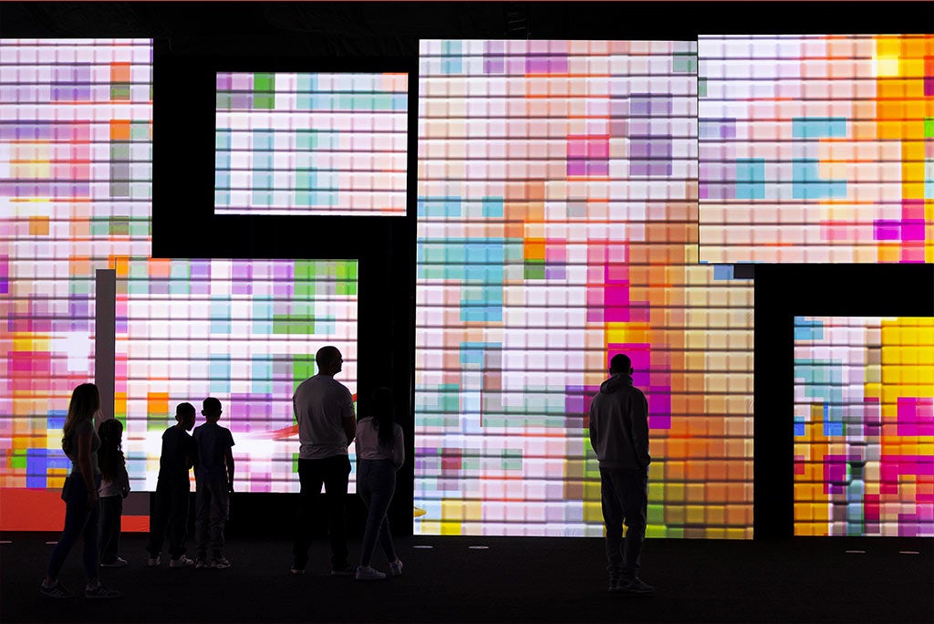 People in front of coloured squares