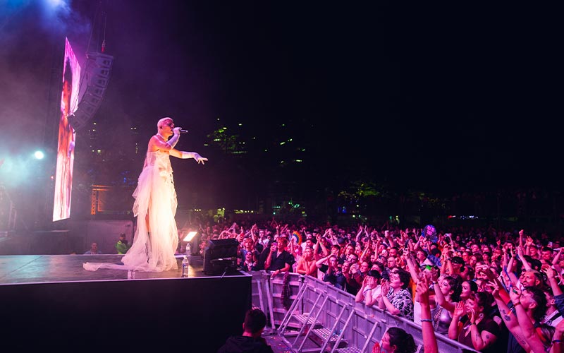 Person on stage singing to crowd