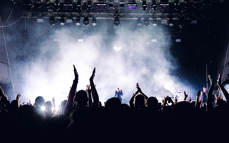 People inside a gig arms raised