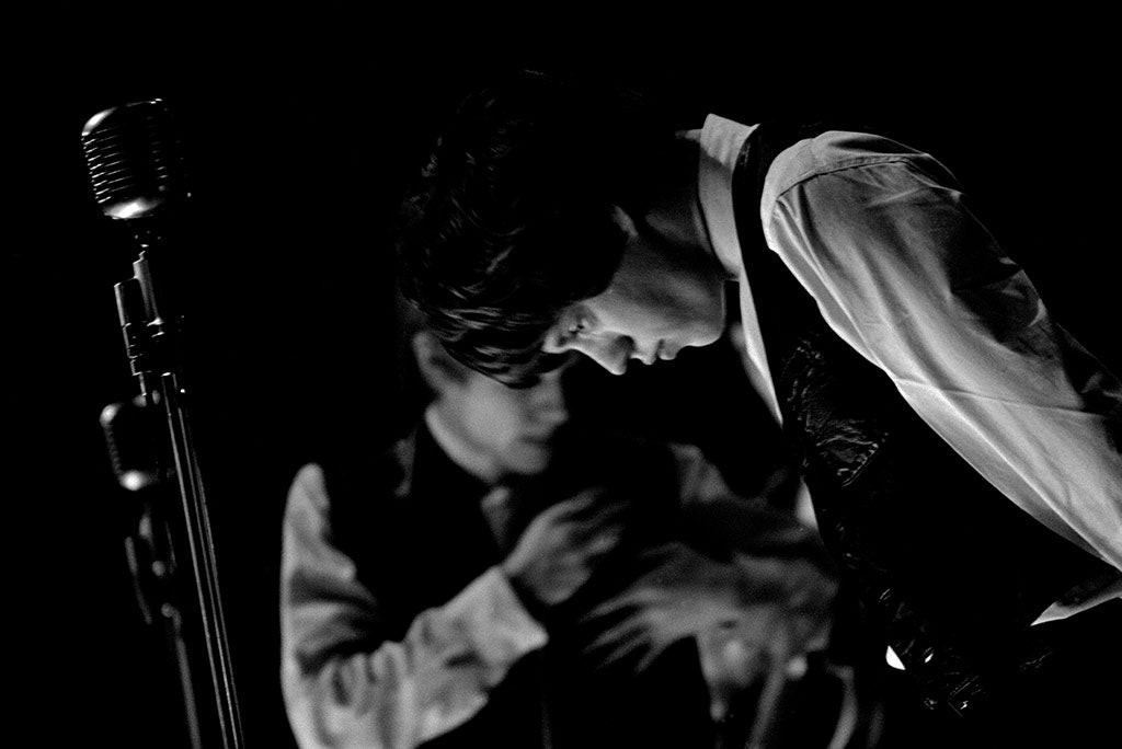 Rolling Stone Artwork - low lit stage shot of two band mates