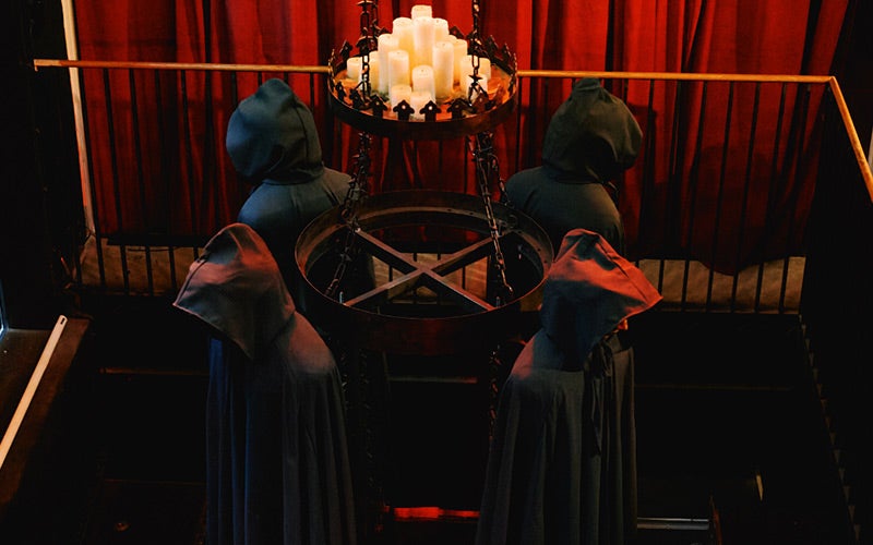 Four people in hoods